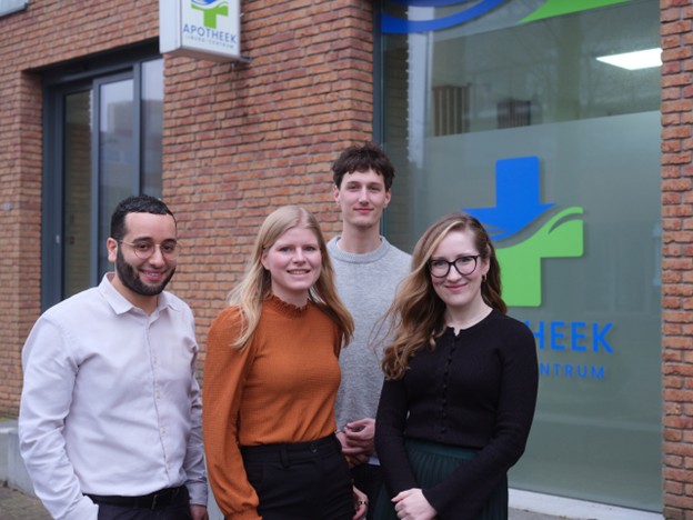 Hoofdapotheker Yassir Boubkary van Apotheek IJburg-Centrum staat samen met zijn team voor de ingang van de apotheek.